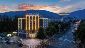 A hotel with a modern facade, multiple floors, and a prominent entrance. - TianQuan Tianyi Jiacheng Hotel (Tianquan)