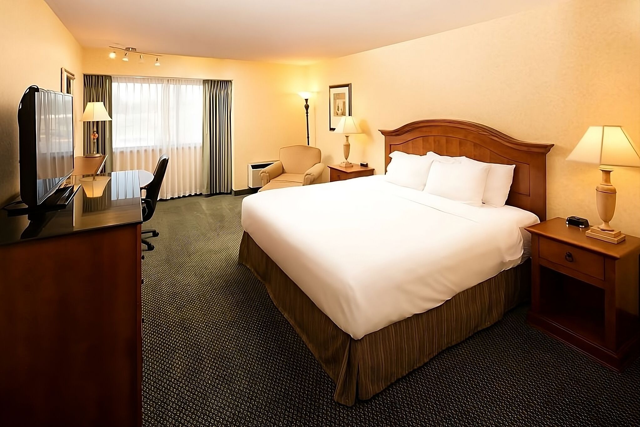 Unwind in a spacious king room with cozy seating.