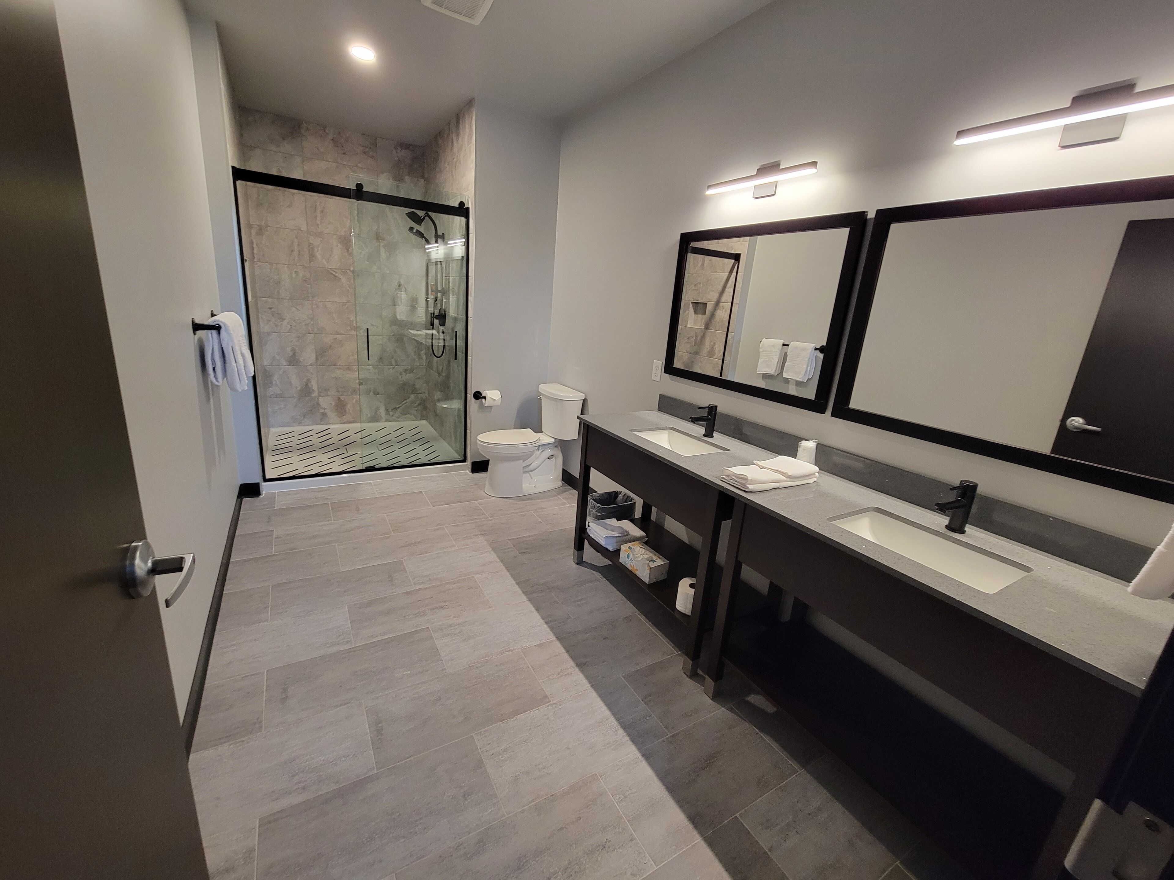 executive suite river and street view | bathroom | shower, rainfall showerhead, towels