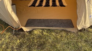 A tent with a bed, a small table, and a bench. - Impeccable 1-bed Bell Tent Near Holyhead (Holyhead)