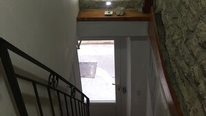 A staircase leading to a loft with a stone wall and a skylight. - Apartment Equinox-Island Pag (Pag)