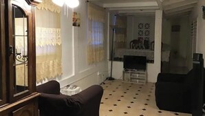 A living room with a ceiling fan, a fireplace, and a television. - 3 BR/ 2 full baths unit with south shore view. (Christiansted)