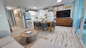 A modern kitchen with white cabinets, a built-in oven, and a large window. - Guest Favorite • Beachfront Luquillo Condo • Walk to Kioskos & El Yunque (Luquillo)