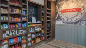 A snack display with various packaged treats and a chalkboard sign saying "Happy New Years!". - Hampton Inn Williams (Williams)