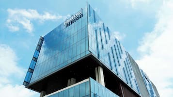 Contemporary hotel building with a glass facade and metal accents.