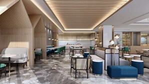 A modern restaurant interior with a central dining area, booths, and a bar. - Hilton Garden Inn Liaocheng Jiangbei Shuicheng (Liaocheng)