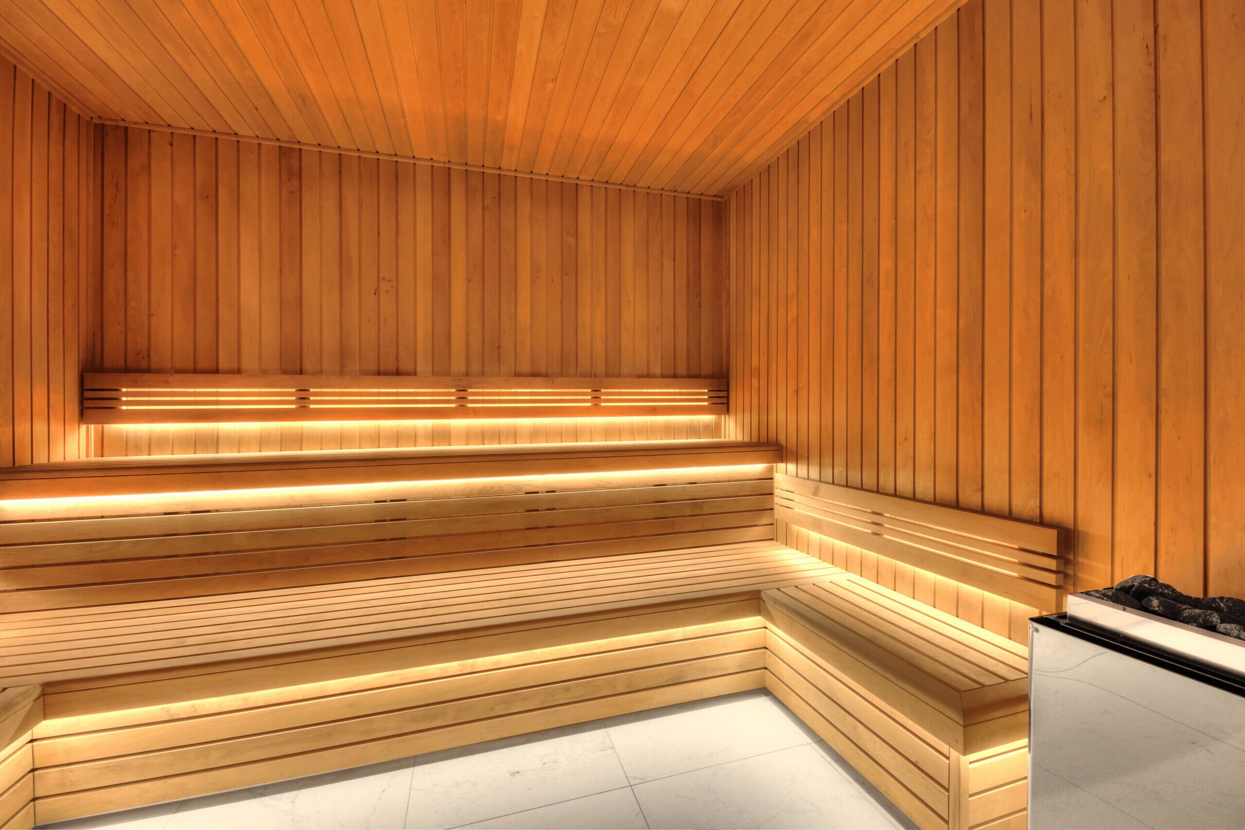 A sauna with wooden benches and a tiled floor.