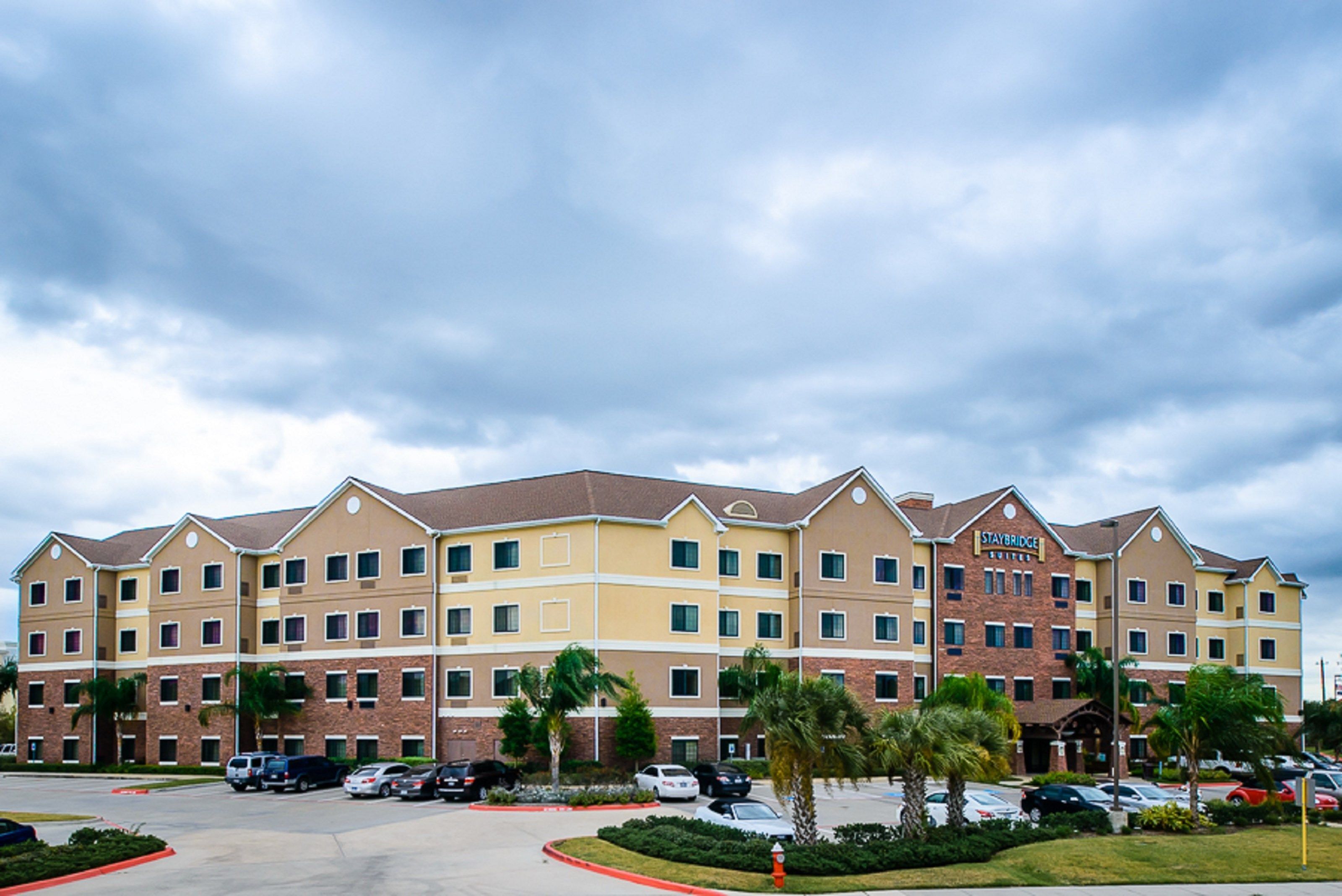 A multi-story hotel with a brick facade and a flat roof.