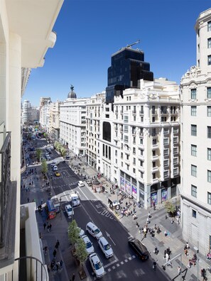 A busy urban street with historic buildings, a clear sky, and a tram. - Hotel Montera Madrid, Curio Collection By Hilton (Madrid)