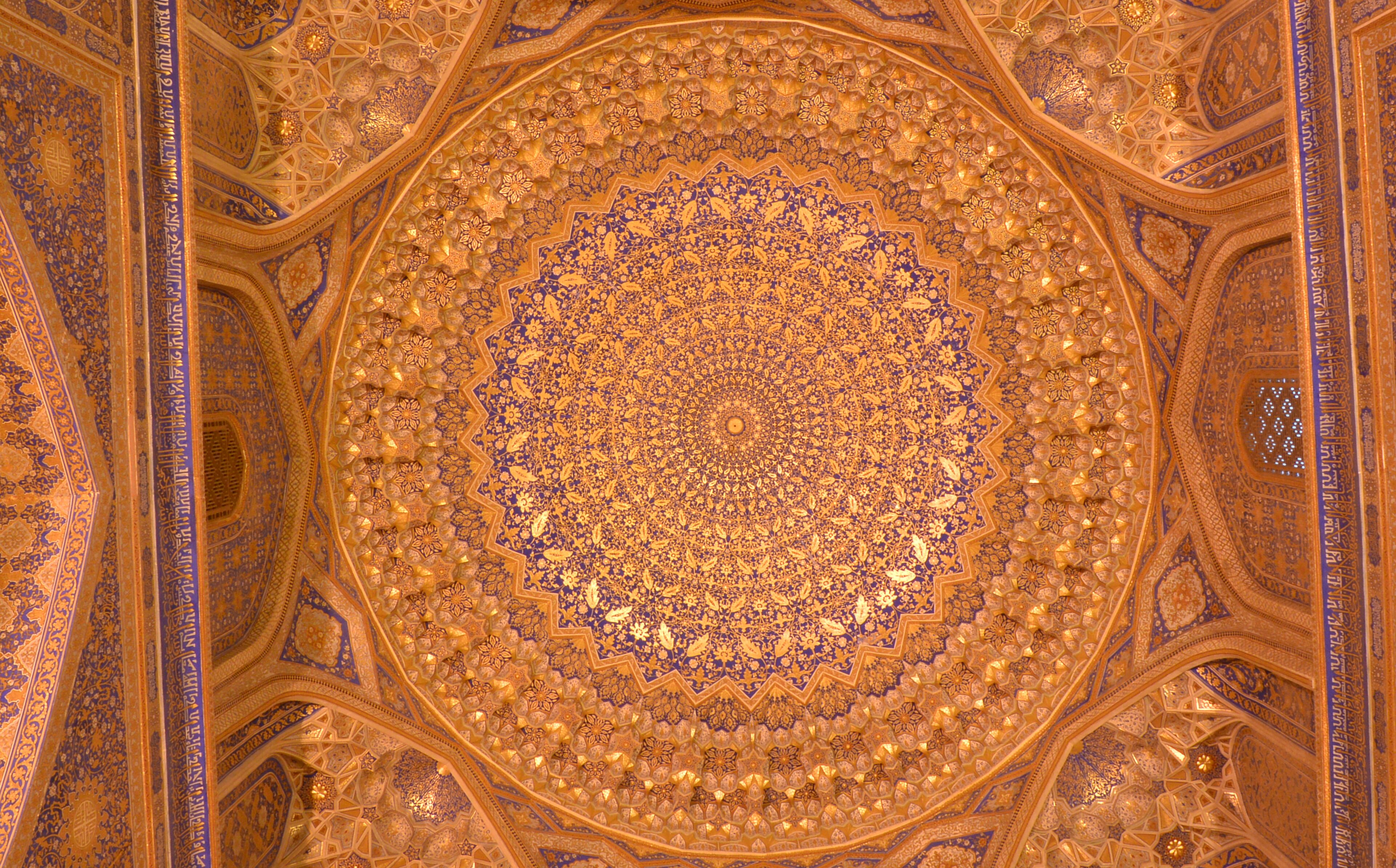 A detailed view of a domed ceiling with intricate geometric and floral patterns, likely part of a historical or religious building.