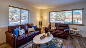 A living room with two leather sofas, a coffee table, and a small side table. - NEW Condo in Core Area! (Pagosa Springs)
