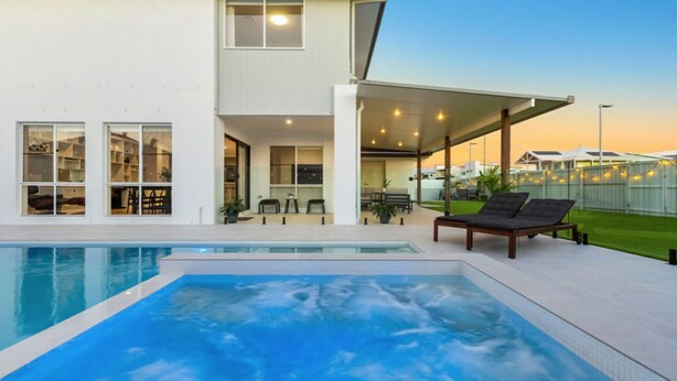A modern house with a swimming pool, outdoor seating, and a covered patio area. - Putt Putt - Pool Slide - 100m to Beach - Ultimate Family Entertainer (Kingscliff)