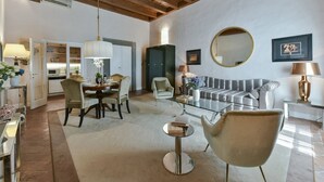 A modern living room with a dining area, a sofa, and a coffee table. - Boccaccio elegant apartment in Oltrarno (Firenze)