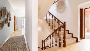 A staircase with wooden balusters and a textured wall decoration.