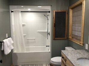 Combined shower/bathtub, towels, soap, shampoo