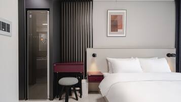Una habitación de hotel moderna con una cama, un escritorio y una silla.