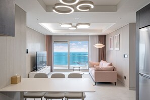 Family Three Room Ocean | Living area | 65-inch Smart TV with cable channels, TV, heated floors - Le Collective Busan Gijang (Busan)