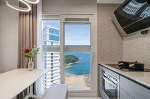 Cocina moderna con vista al mar, zona de comedor y un amplio ventanal.
