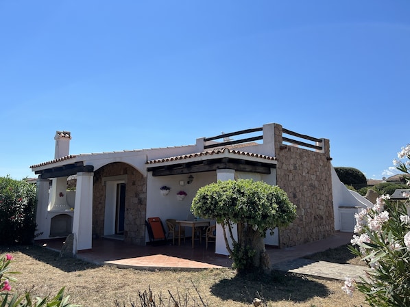 Traditional Mediterranean-style villa with a patio area and garden.
