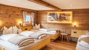 A wooden cabin-style bedroom with two beds, a chair, and a desk. - Neuhaus Alm Holiday Home with Mountain Views, Open Terrace and Wi-Fi (Gerlosberg)