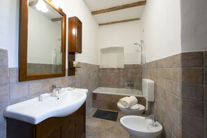 A bathroom with a white sink, a mirror, a toilet, and a bathtub. - Timeless l' Antico  Mulino Della Bozza, Brebbia, Italy (Brebbia)