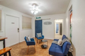 Living room - 3-bedroom unit with private entrance, private bathroom, full kitchen, living and dining area, workspace, and laundry. (Orlando)