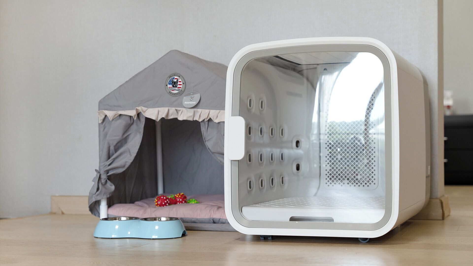 A pet bed with a small house-like structure and a feeding bowl.