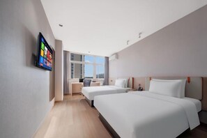 A modern hotel room with two beds, a desk, and a large window offering a city view. - dinghaophotel (Taizhou)