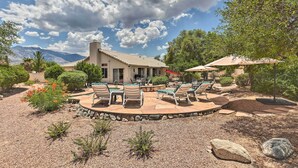 A patio area with outdoor furniture, a pool, and a view of mountains. - Saddlebrooke Home w/ Private Pool & Amenities (Tucson)