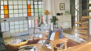 A modern living room with a large stained glass window, a wooden dining table, and a staircase leading to an upper level. - 3 Br by park hayarkon 1min  2 Ichilov (Tel Aviv)
