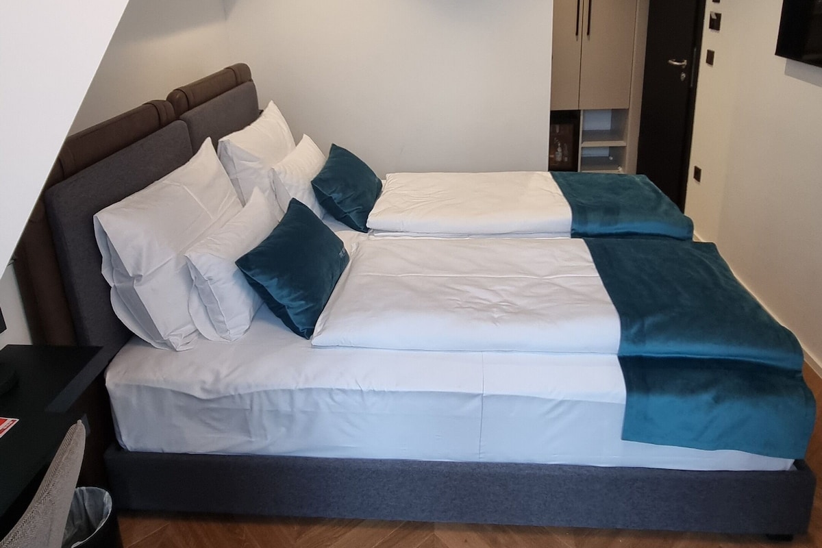 Premium bedding, down duvets, desk, laptop workspace