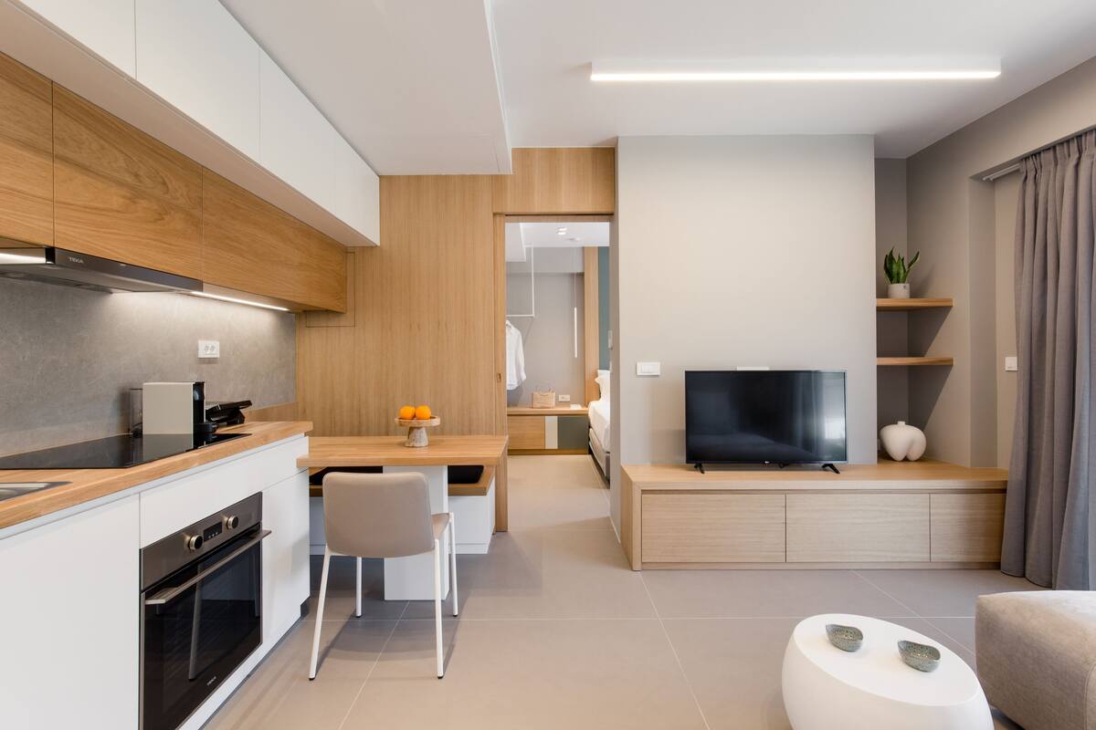 Una cocina moderna con comedor, televisor y zona de estar.