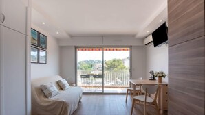 A modern bedroom with a bed, a desk, and a TV. - Les Pradels by Interhome (Cavalaire)