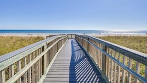 A wooden boardwalk leading to a beach with clear skies. - New Private Ashworth Resort Direct Oceanfront View (North Myrtle Beach)