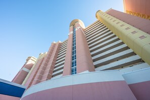 Experience the unique architectural design of this hotel, featuring a central tower with a glass facade offering views of the surrounding area.