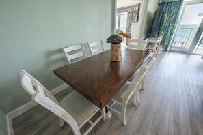 Enjoy meals in this dining area with a long table and comfortable chairs.
