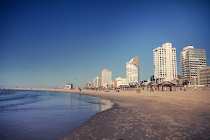 A beach with high-rise buildings in the background. - Brut Seafront Hotel By Sunday (Tel Aviv)