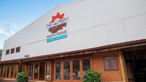 A building with a sign reading 'The Factory Nougat & Chocolate Central Coast NSW.' - Bay House Motel (Bateau Bay)
