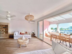 Relax in this serene bedroom with a comfortable bed, round side table, and ceiling fan.
