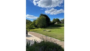 A landscaped garden with a lawn, trees, and a pathway. - Maison de Maître Gironde built in 1896 and fully restored (saint philippe d'aiguille)