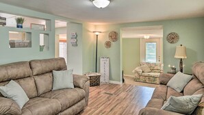 A living room with two brown sofas, a coffee table, and a lamp. There are decorative wall pieces and a sign that says "Simply Blessed." - Peaceful Satsuma Escape w/ Dunns Creek Access (Satsuma)