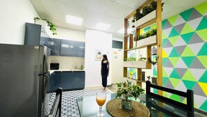 A modern kitchen with a refrigerator, microwave, and sink.