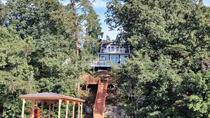 A lakeside property with a dock, a gazebo, and a large house with a balcony overlooking the water. - Sunset Cottage on Badin Lake, NC! (New London)