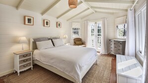 A bedroom with a bed, nightstands, a dresser, and a window with curtains. - Cute Cottage with Log Burning Fire, close to Wineries (Megalong Valley)