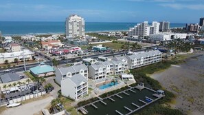 A coastal hotel with multiple buildings, a swimming pool, and a marina. - Tortuga Bay 3 Bedroom Home by RedAwning (South Padre Island)