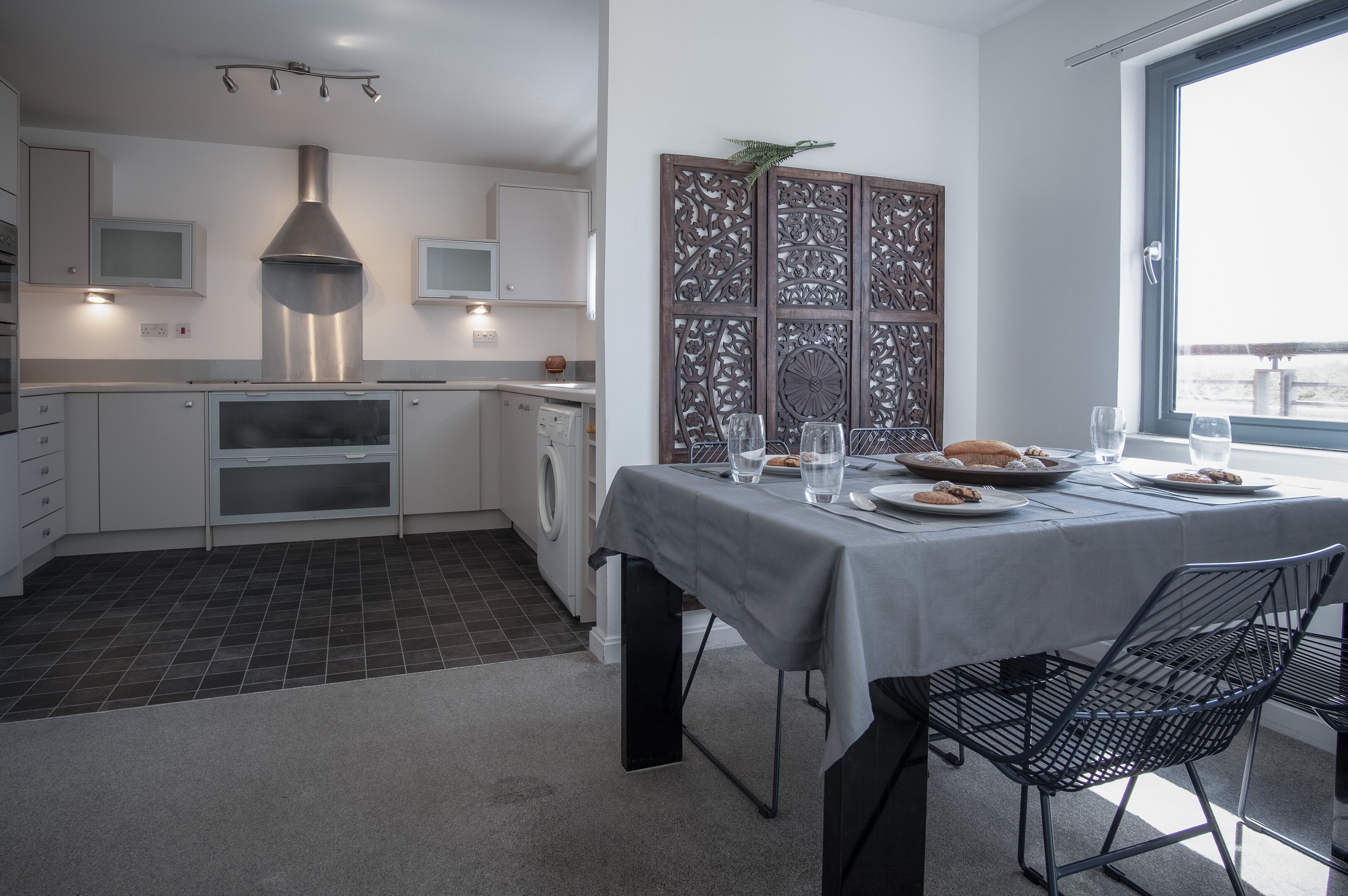 A modern kitchen with a dining area.