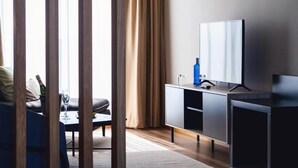 A modern living room with a sofa, a coffee table, a television on a stand, and a cabinet. - Select Porto (Porto)