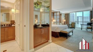 A hotel room with a large bed, a desk, and a view of the city. - MGM Signature-Strip View Tower 2  Jacuzzi Studio (Las Vegas)