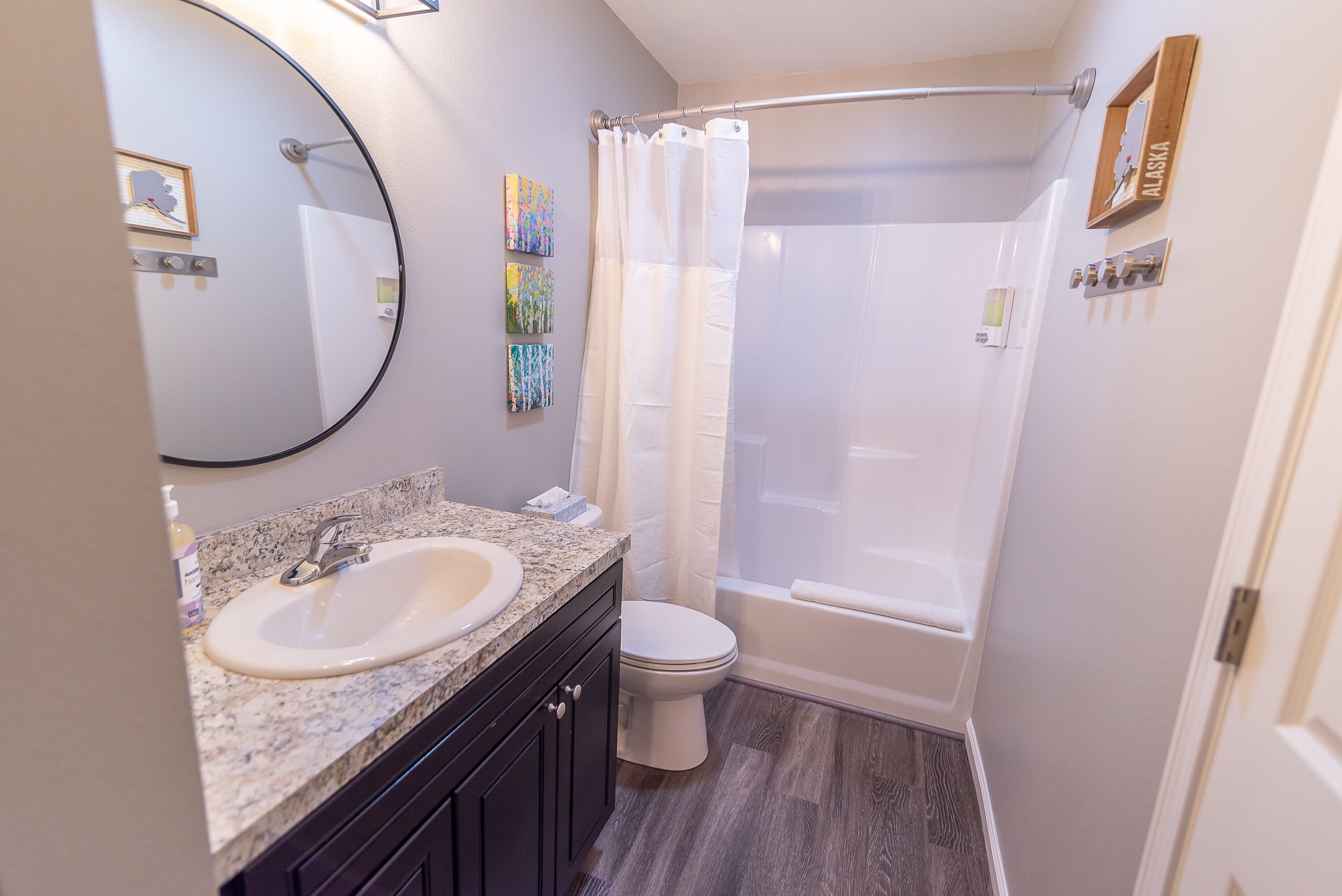A bathroom with a sink, toilet, and bathtub.