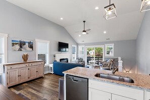 Enjoy cooking in this well-equipped kitchen with a central island, dishwasher, and large window offering a view of the outdoors.